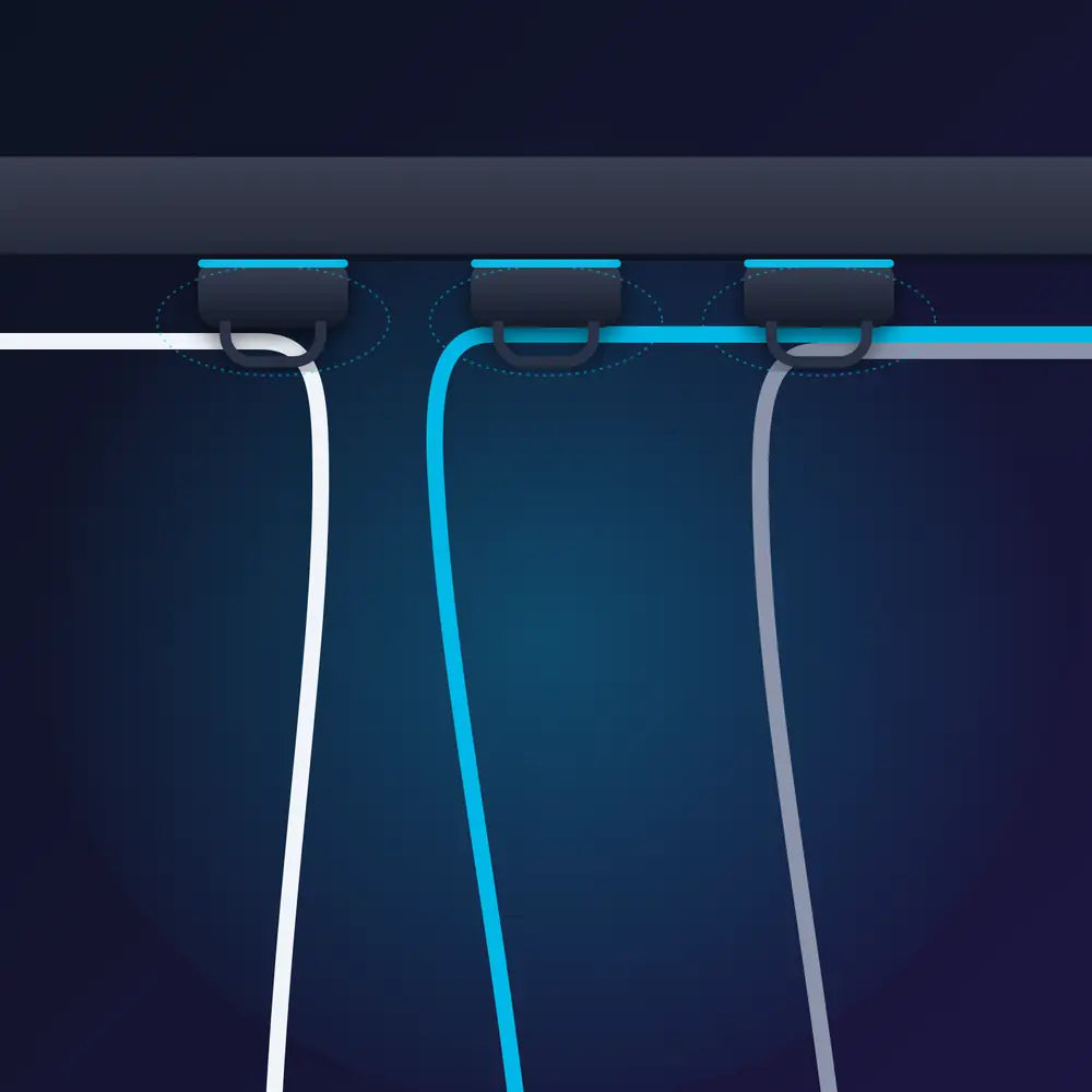 Magnetic cable clips holding cables under a desk