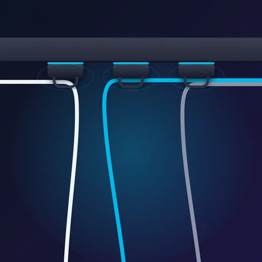 Magnetic cable clips holding cables under a desk