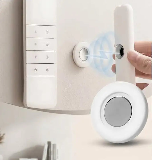 Magnetic remote holder on a wall holding a remote control